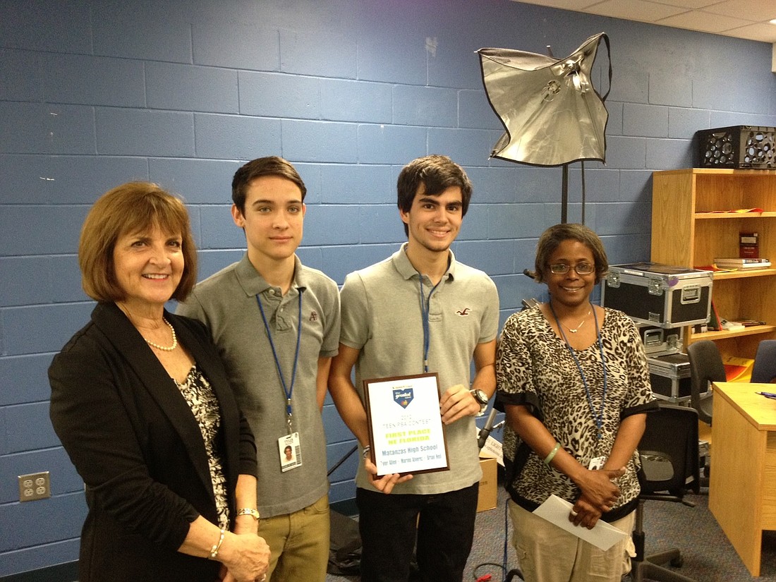 Nancy Sebastian, director of KinderVision Foundation, winning students Tyler Allen and Brian Heil, and Matanzas High School video production teacher Tracey Hicks