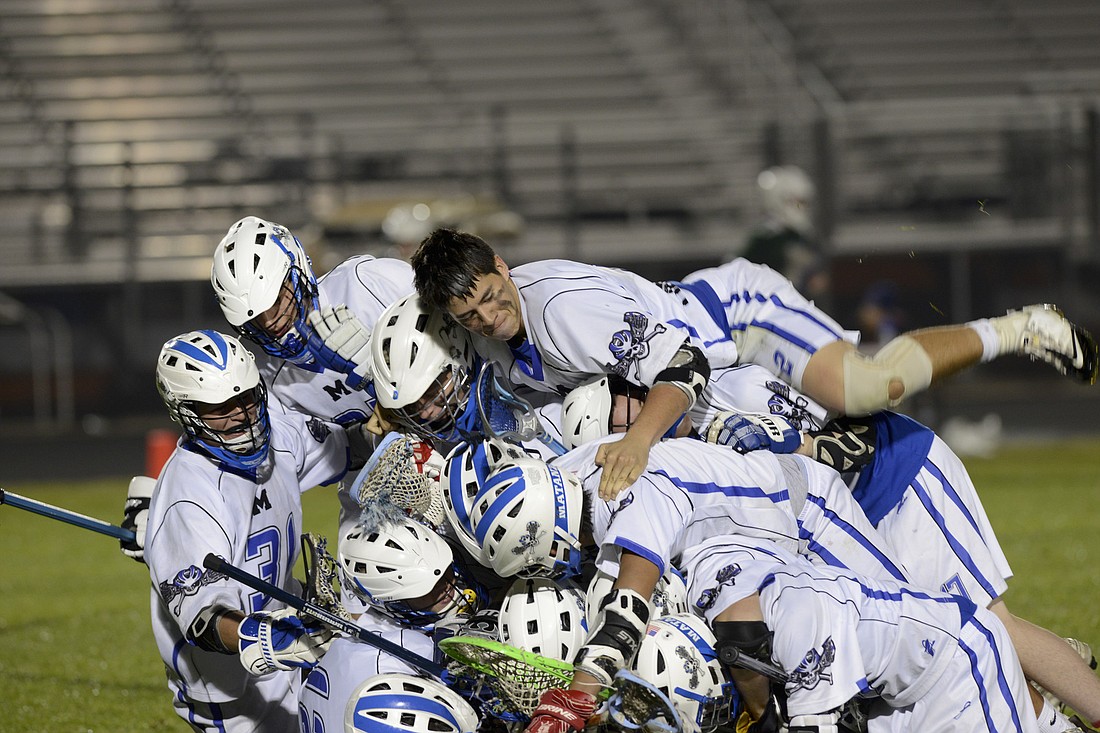 The Matanzas Pirates (4-1) celebrate their 11-8 win over Flagler Palm Coast on Friday night. (Photo by Steven Libby/Coyote Photography)