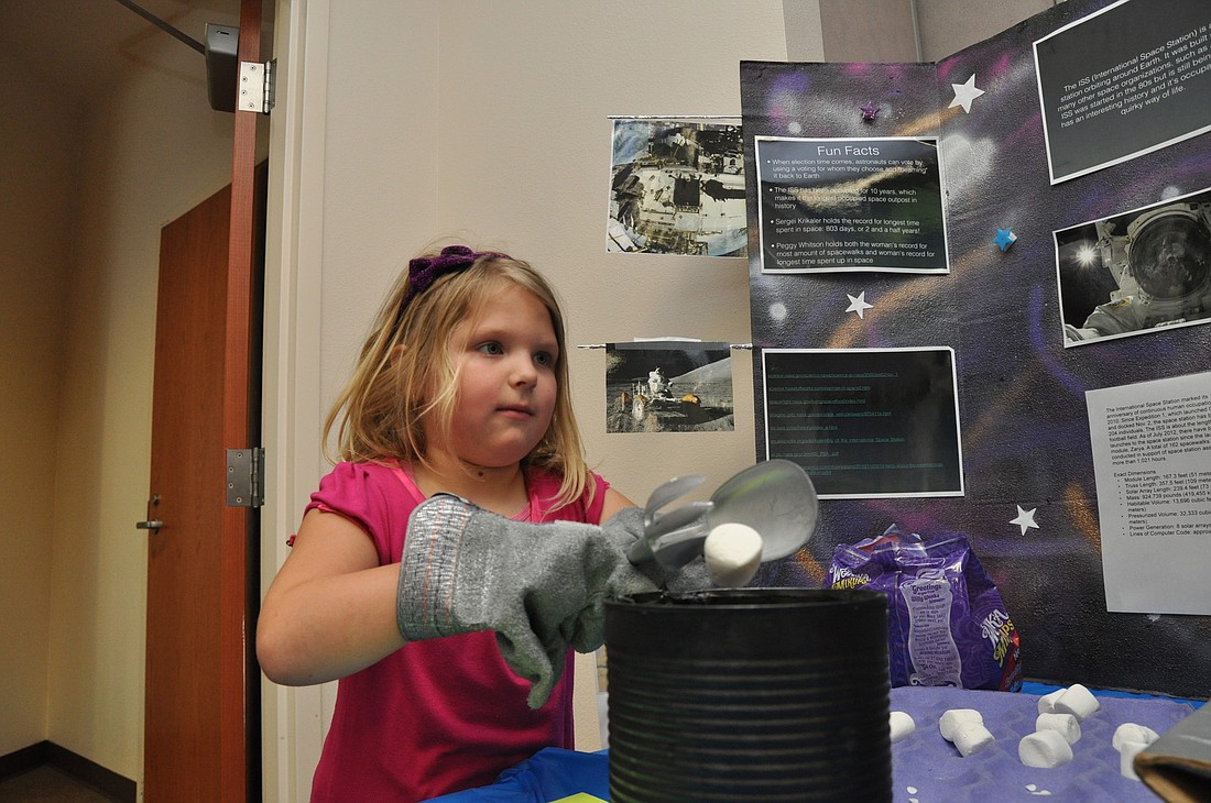 Addison Davis, 5, attempts to move like a robot at the Indian Trails Middle School service learning activity, Stars!