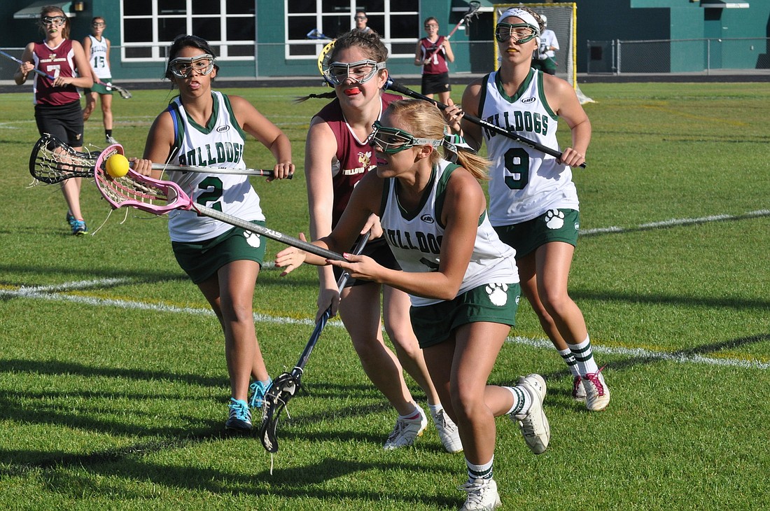FPC senior Kim Ramirez fights for the ball Thursday against St. Augustine in a District 4 girls lacrosse matchup. FPC won the game, 14-4.