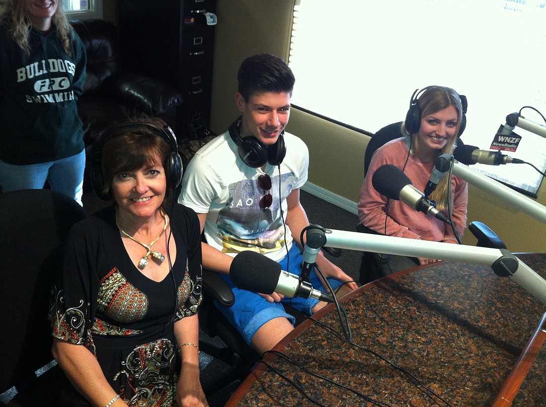 Jeanette Loftus, international service chairwoman for the Rotary Club of Flagler, preps for air time on WNZFÃ¢â‚¬â„¢s Free For All Friday, with German exchange students Max Bergold and Anna Senfleben. PHOTO BY BRIAN MCMILLAN