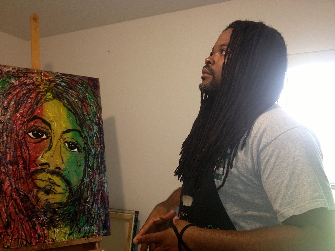Onicas Gaddis ponders over his piece, "Who am I," which will be part of his show at Ocean Books & Art.