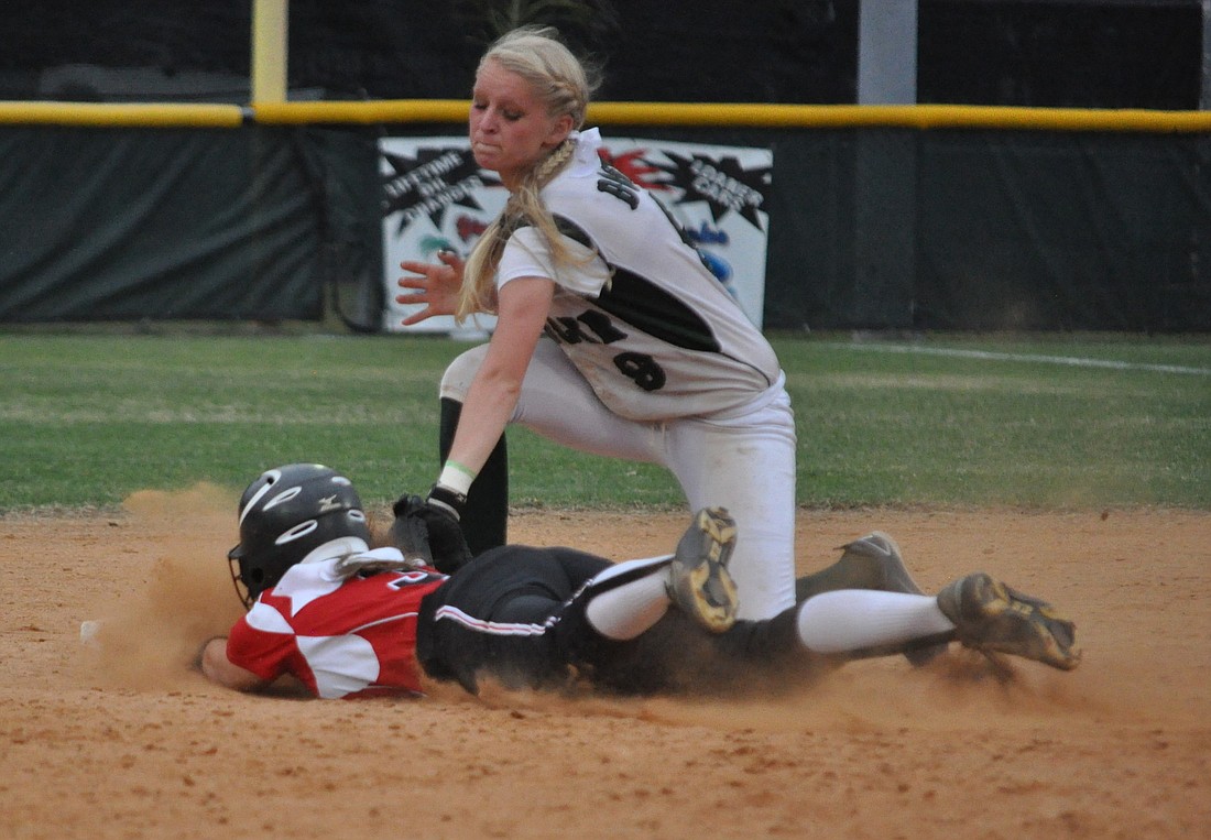 FPC senior shortstop Destiny Kelly attempts to slap the tag on a Creekside baserunner in Friday's game.  Kelly went 2-for-2 at the plate. ANDREW O'BRIEN