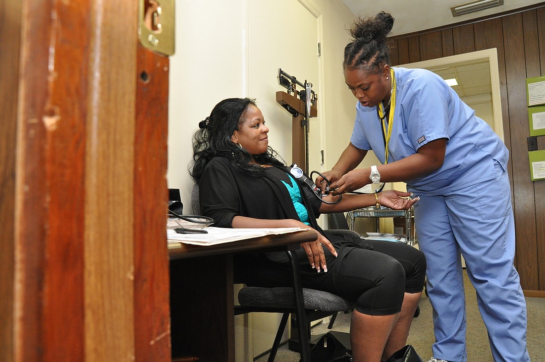 Sherri Griffin, 54, gets her blood pressure taken by volunteer Holly Neal. FILE PHOTO BY SHANNA FORTIER