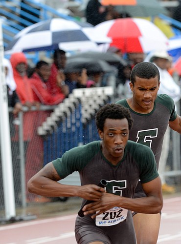 Eddie Mutungu receives the handoff from Turrel Mathews heading into the second leg of the 4x400-meter relay. FPC finished second in the state.