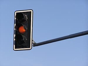 The state dropped three words from its rules, a move critics say was meant to generate more red light citation revenue for the state at the expense of drivers' safety.