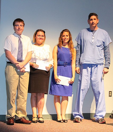 Florida Hospital Flagler's 2013 scholarship recipients Michael Fitz, Felicity Furtado and Cindy Orosz stand with presenter and Florida Hospital Flagler Chief of Staff Elect Anesthesiologist Dr. Glenn Zimmet. COURTESY PHOTOS