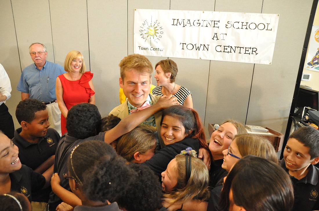 Brett Cunningham's students surround him after learning he won the 2013 National Teacher of the Year in the Imagine School charter system. PHOTOS BY SHANNA FORTIER