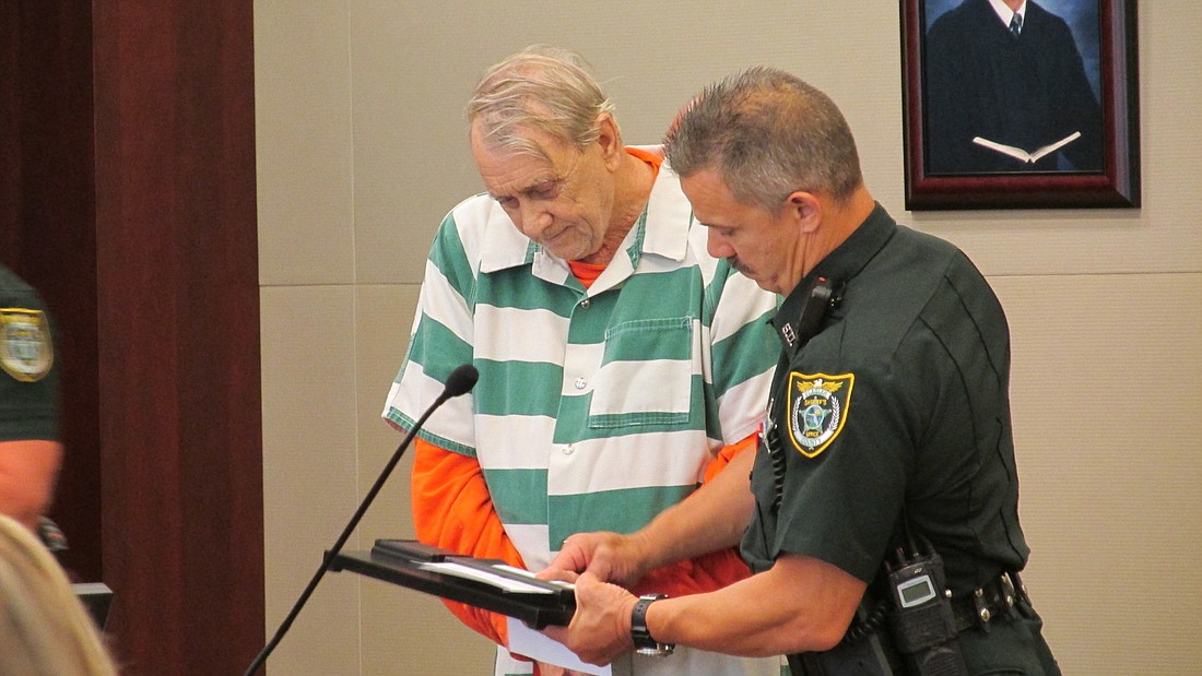 Paul Miller's hands shook as the bailiff took his fingerprints after his sentencing. Photo by Megan Hoye