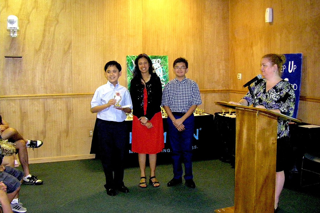 Augusto "Trey" DeLeon III, a seventh-grader at Indian Trails Middle School; Director Mita Tomerlin; and Andoni Alfonso, a sixth-grader at St. Elizabeth Ann Seton