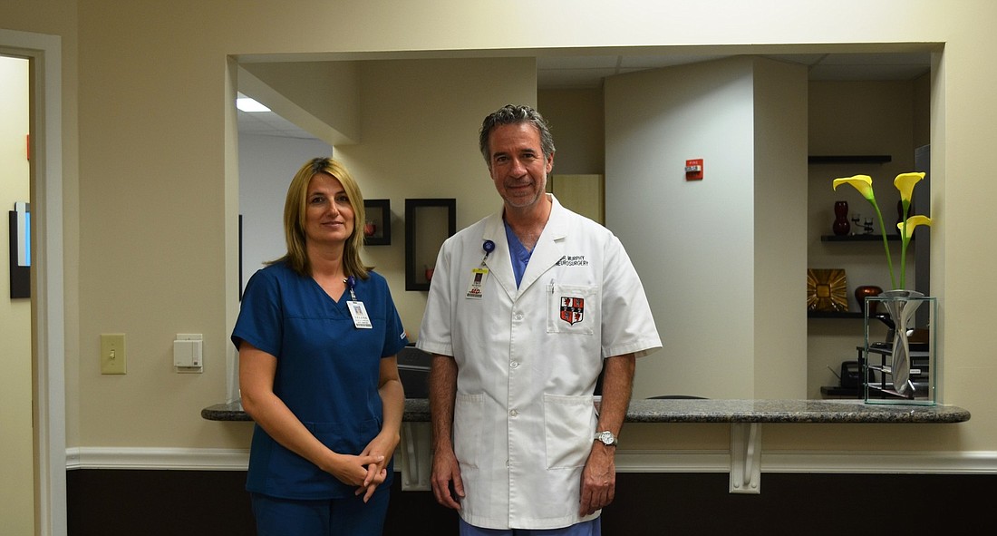 Yelena Kozorezova, certified medical assistant, and Florida Hospital Memorial Medical Center neurosurgeon Dr. Mark Murphy in Murphy's new office. Courtesy photos.