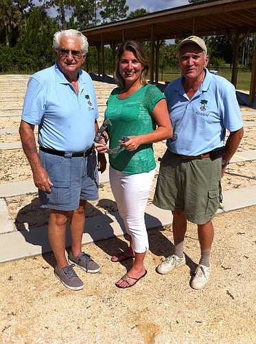 Tom Martone (left) and Howard Hawes (right), of the Flagler County Horseshoe Pitching Club, with Casey Ryan, of Palm Coast and the Flagler Beaches tourism office. COURTESY PHOTO