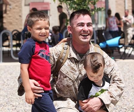 U.S. Marine Corps Capt. Jeremy Thomas is greeted by Liam (left) and Ian Goldsborough. The Goldsboroughs are the children of Thomas' friend. They spend holidays with Thomas on the west coast. COURTESY PHOTO