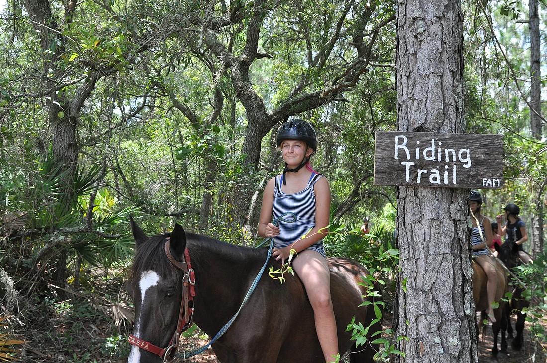 Dona Hoffman rides a Florida Cracker horse on a trail at the Florida Agricultural Museum. PHOTOS BY SHANNA FORTIER