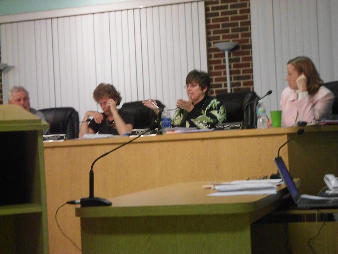 Kim Carney, middle, initially suggested looking into a merger to cut costs and increase safety in the city. File photo.