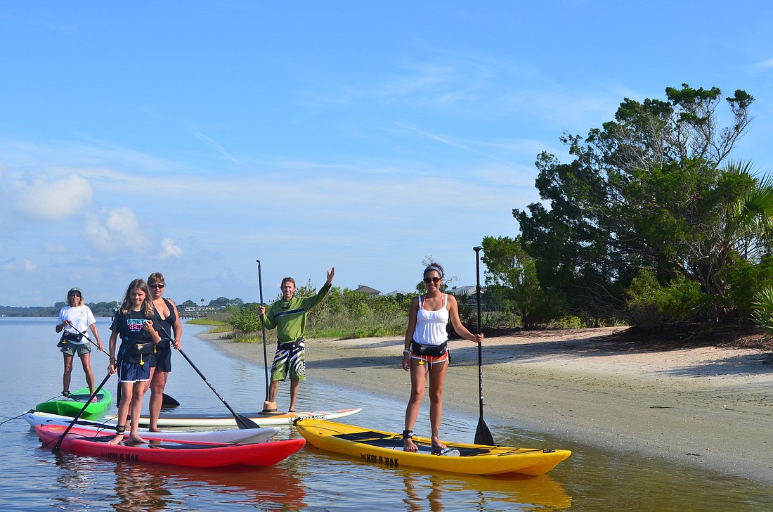 Roll 'N' Float Outfitters owner, Mark Imhoof, takes paddleboarders to One Tree Beach near Gamble Rogers State Park.