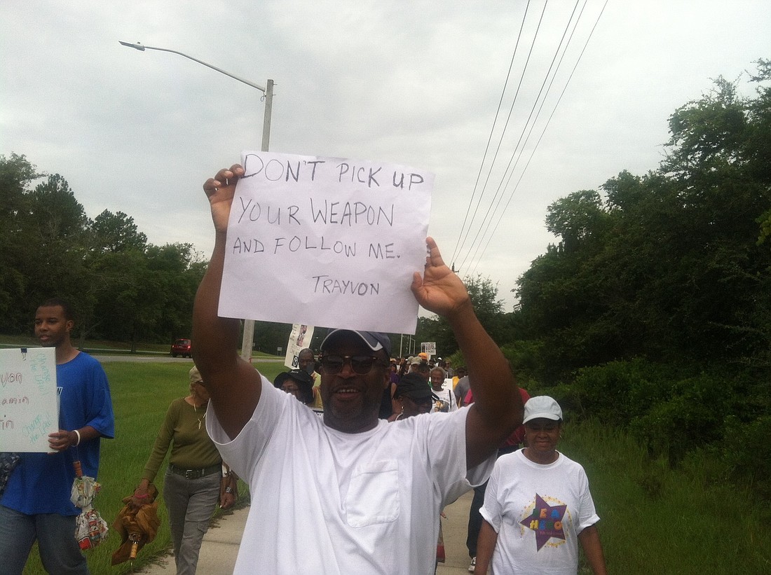 Ken Bell marches in Saturday's peaceful protest. "George Zimmerman picked up his gun and followed Trayvon Martin like he was on the battlefield," he says.