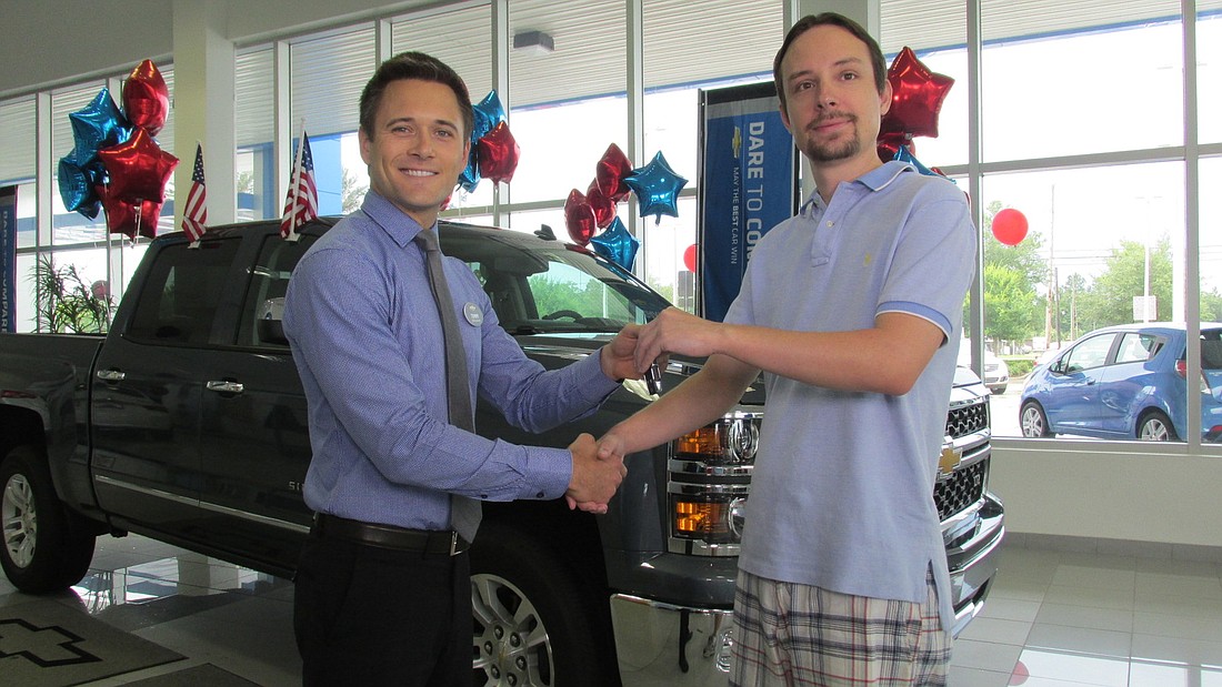Tommy Gibbs presents Daniel Holland with his new Chevrolet Silverado.
