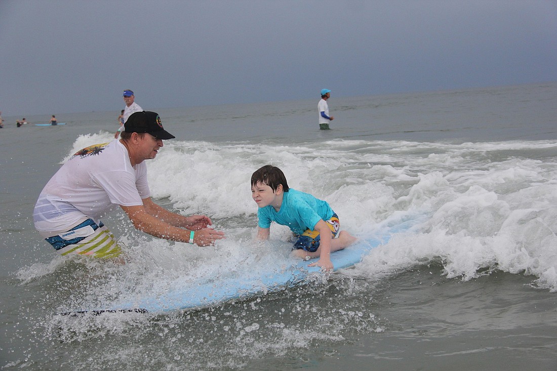 Bobby Mantell, 7, rides a wave in Saturday morning. PHOTOS BY SHANNA FORTER