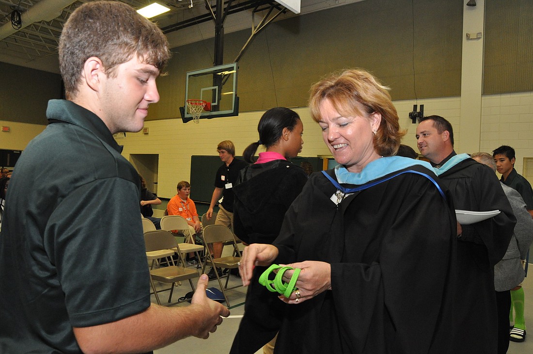 Carson Moree is presented with a bracelet from FPC Principal Lynnette Shott as a reminder of his commitment to graduate. PHOTOS BY SHANNA FORTIER