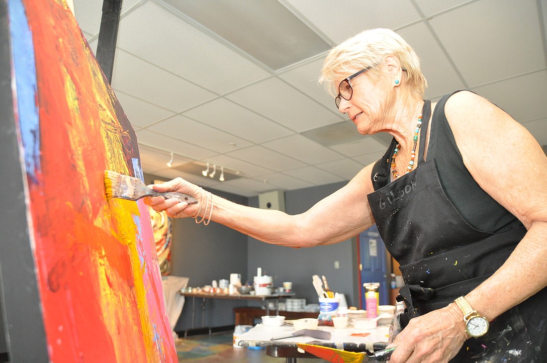Diane Gilson puts the finishing touches on her panting at Hollingsworth Gallery. PHOTO BY SHANNA FORTIER