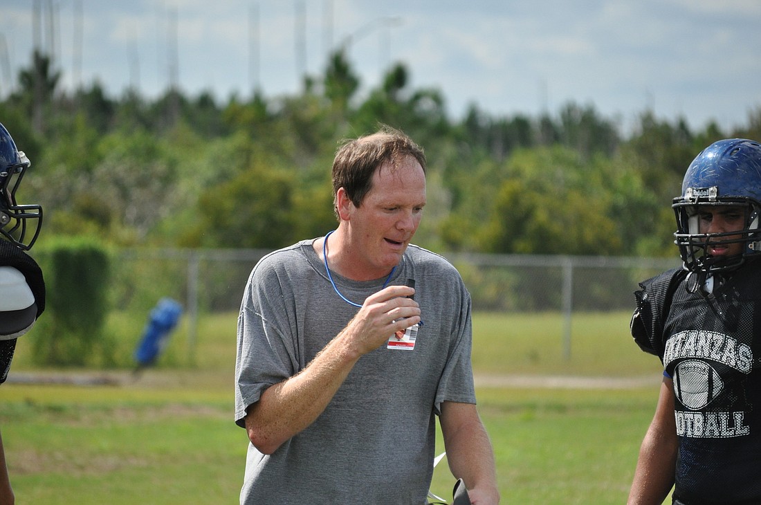 Matanzas coach Jeff Nettles works with his linemen during Monday's practice. PHOTOS BY ANDREW O'BRIEN