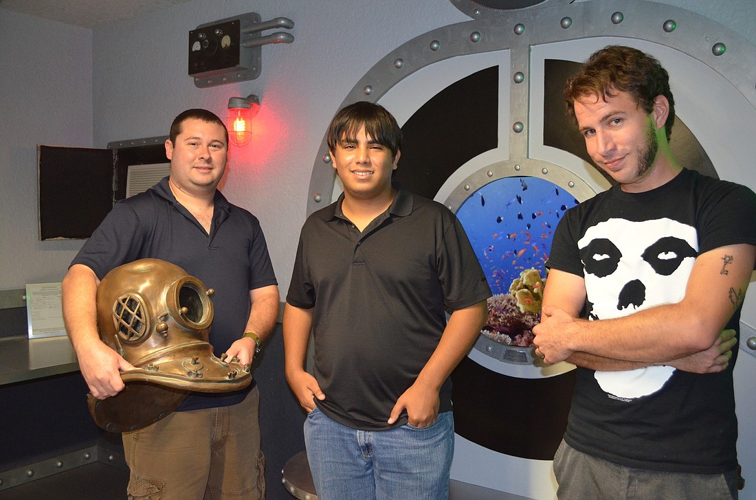 Co-owners, Scott Nance and Lenny Mosco, stand with director, Patrick Appolonia inside the submarine themed offices of 10th Voyage Studios.