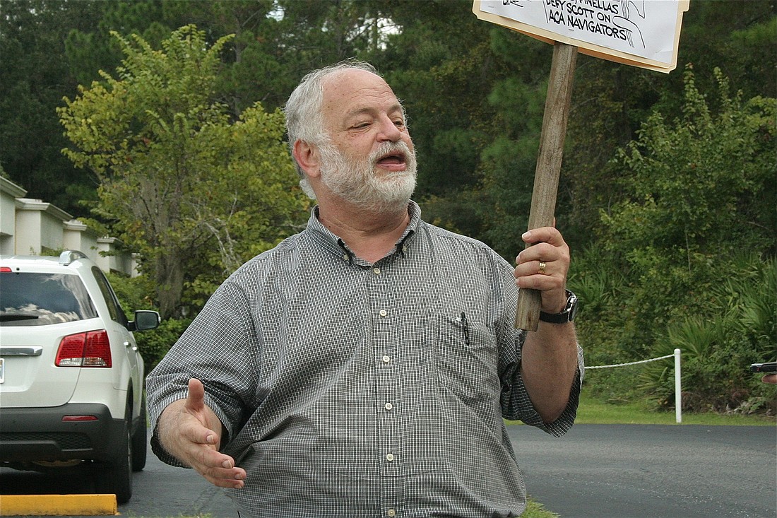 Flagler County Democratic Club President Merrill Shapiro speaks in  support of the Affordable Care Act at a rally in front of the Flagler County Health Department Tuesday, Oct 1, 2013