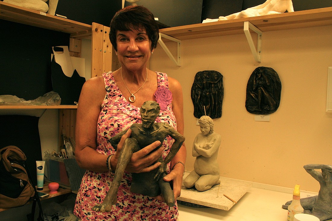 Palm Coast artist Marilyn Leverton holds her earthenware sculpture, "Pandora's Box," which will be shown Oct. 12, at the Hollingsworth Gallery's "Saints and Sinners" show.