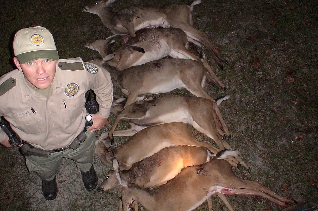 FWC Officer Eric Meade, of Flagler County, poses with seven deer taken by a poacher he caught in 2008. Courtesy photo.