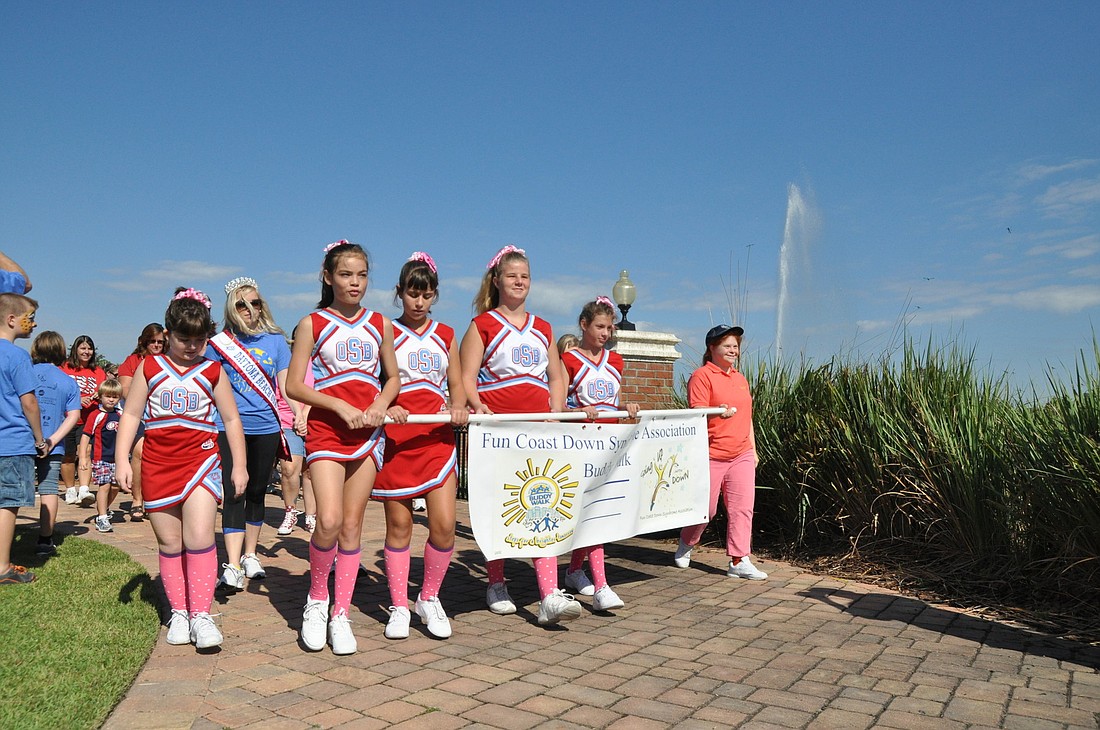 The Ormond Beach Sandcrab Stars cheer squard led the eighth-annual Buddy Walk Saturday morning at Palm Coast Town Center. PHOTOS BY SHANNA FORTIER