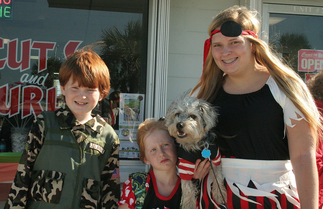 Zebediah Higgs, 9; Matilda Higgs, 6; and Sloan Cambron, 19, with their dog Snickers.