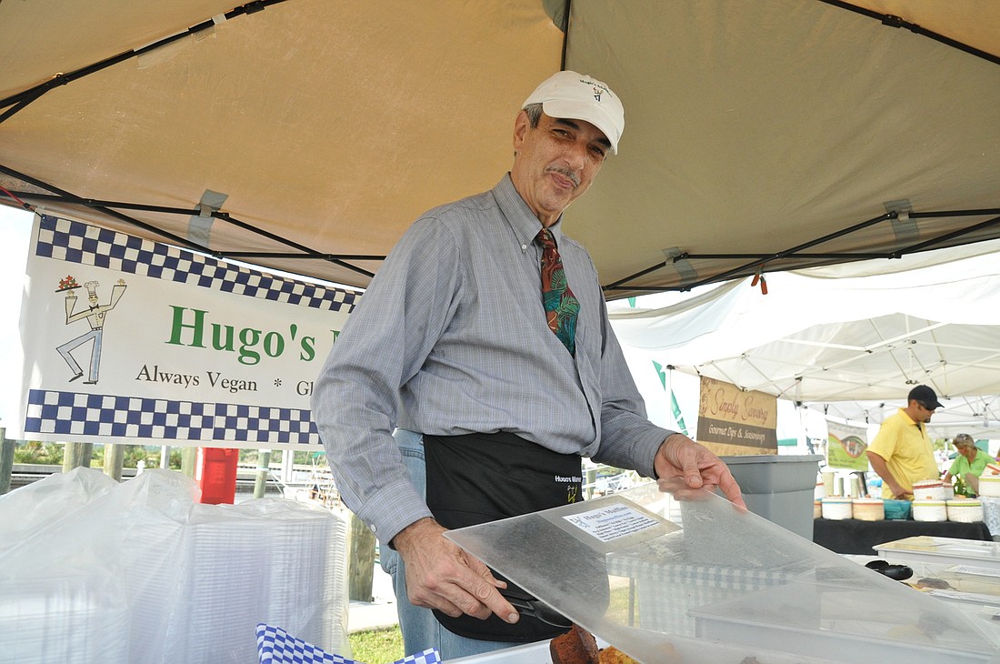 Hugo Brache, of Hugo's Muffins, serves up vegan and gluten-free muffins at the Salt Air Farmers Market. PHOTO BY SHANNA FORTIER