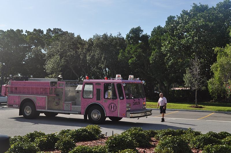 Longboat Key firefighter/paramedic Brandon Desch guided the pink fire truck as it arrived this morning at Longboat Key Publix. Longboat firefighters are wearing pink T-shirts today in support of women's cancer awareness.