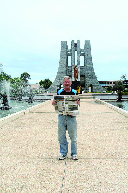 GHANA. Longboat Key resident and global marathoner John Wallace reads The Longboat Observer while visiting the Kwame Nkrumah memorial in Accra, Ghana. Wallace was in Ghana for his 335th marathon in his 105th country, a new world record.
