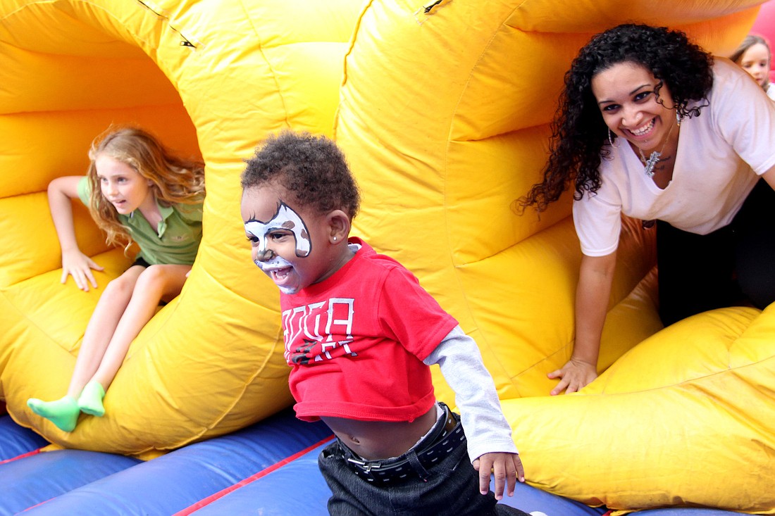 Samantha Rivera chases her son Da'Nayvion Stanley through one of the blow up obstacle courses Saturday. PHOTOS BY SHANNA FORTIER