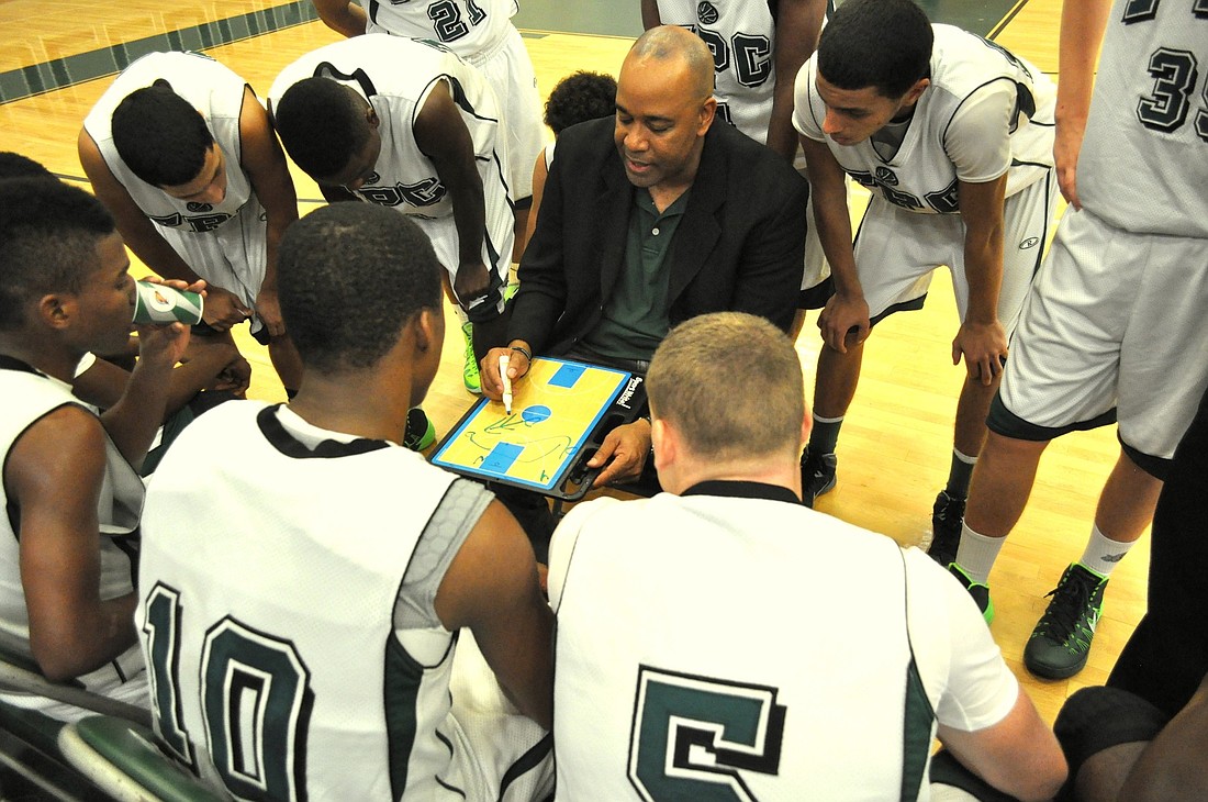 Flagler Palm Coast boys basketball coach Gary McDaniel draws up a play during a timeout on Wednesday. (Photo by Andrew O'Brien)