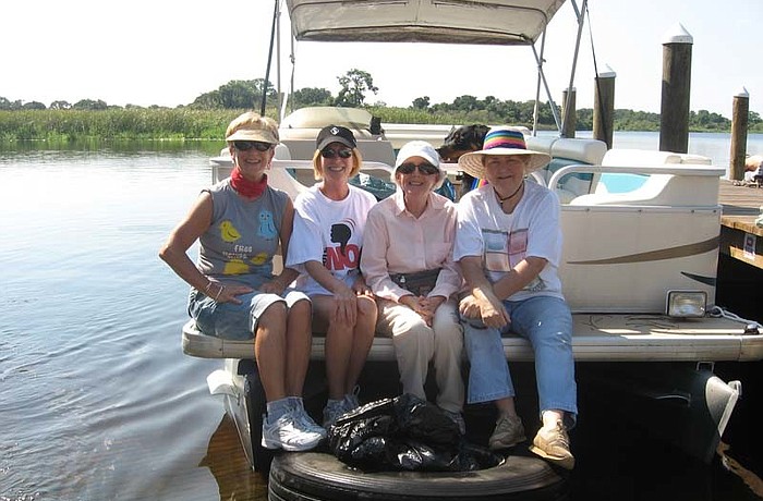 Barbara Wize, Michelle Crabtree, Ann Mcfarlane and Sandra Metcalf are pictured with the truck tire and trash they collected.