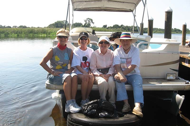 Barbara Wize, Michelle Crabtree, Ann Mcfarlane and Sandra Metcalf are pictured with the truck tire and trash they collected.