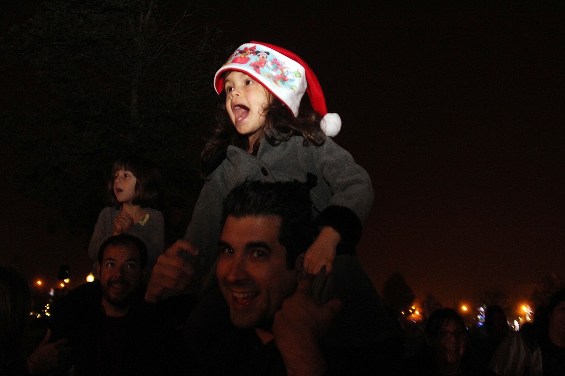 Eliana Rodriguez sits on her dad's shoulders for a better look at Santa. PHOTOS BY SHANNA FORTIER