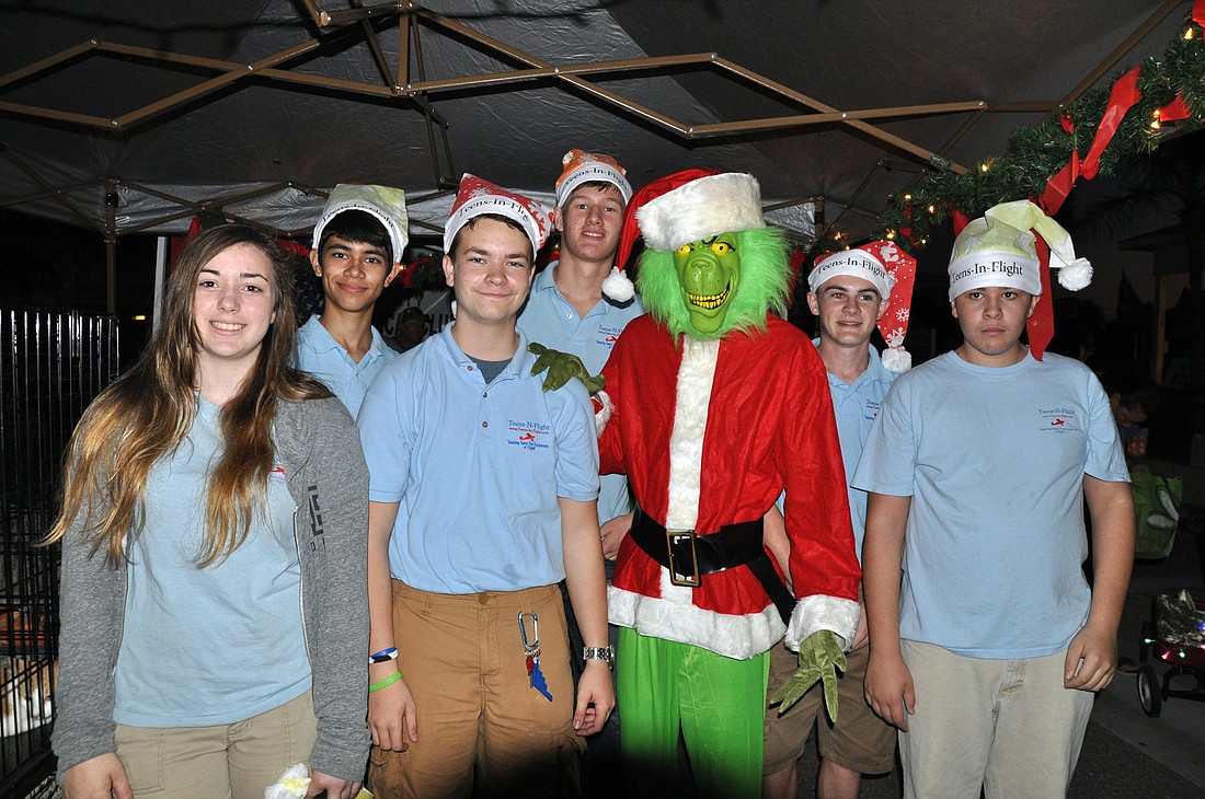 Teens in Flight students pose with the Grinch at First Friday. PHOTOS BY SHANNA FORTIER