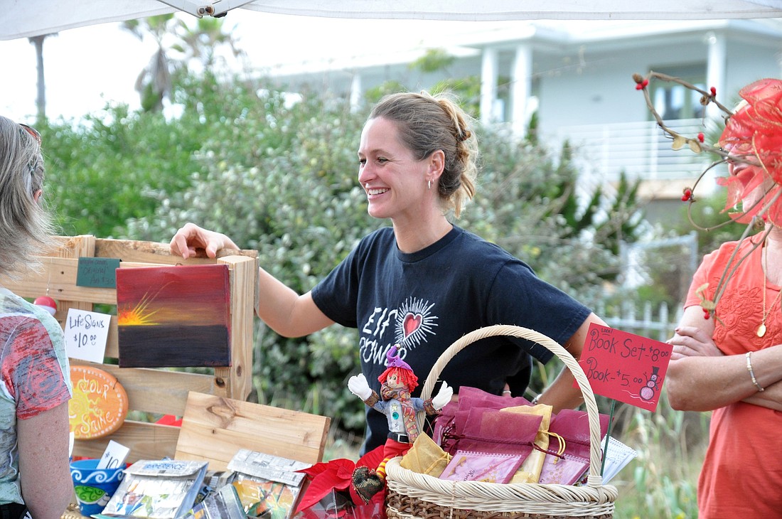 Carla Cline talks to a potential customer at the Holiday Handmade Market. PHOTOS BY SHANNA FORTIER