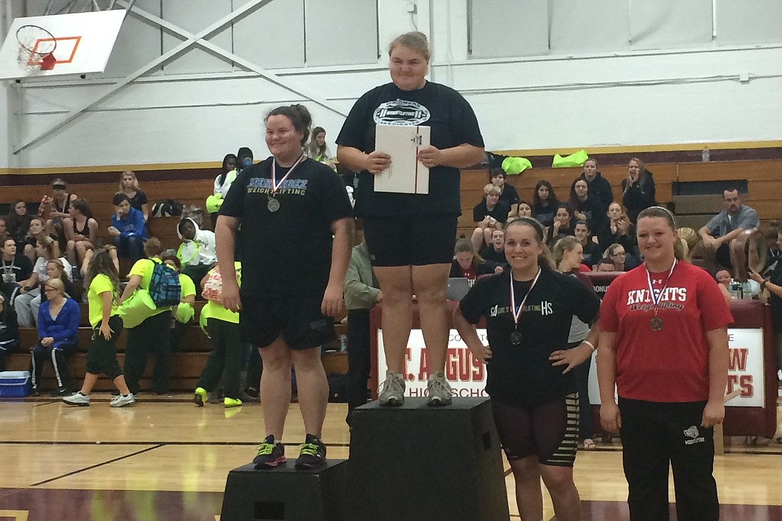 Kayla Short (middle) won the first conference title in Matanzas' history with a 300-pound total in the unlimited class. (Courtesy photo)