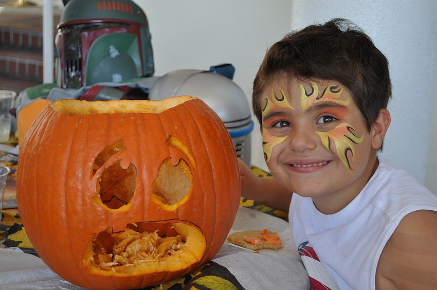 Andre Angelestro, age 6, shows off his pumpkin carving skills.