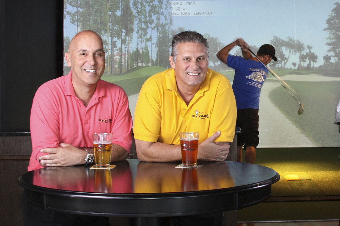 Chris Poulos, left, and Charles Leduc opened the first CaddyShanks in January in the East County.