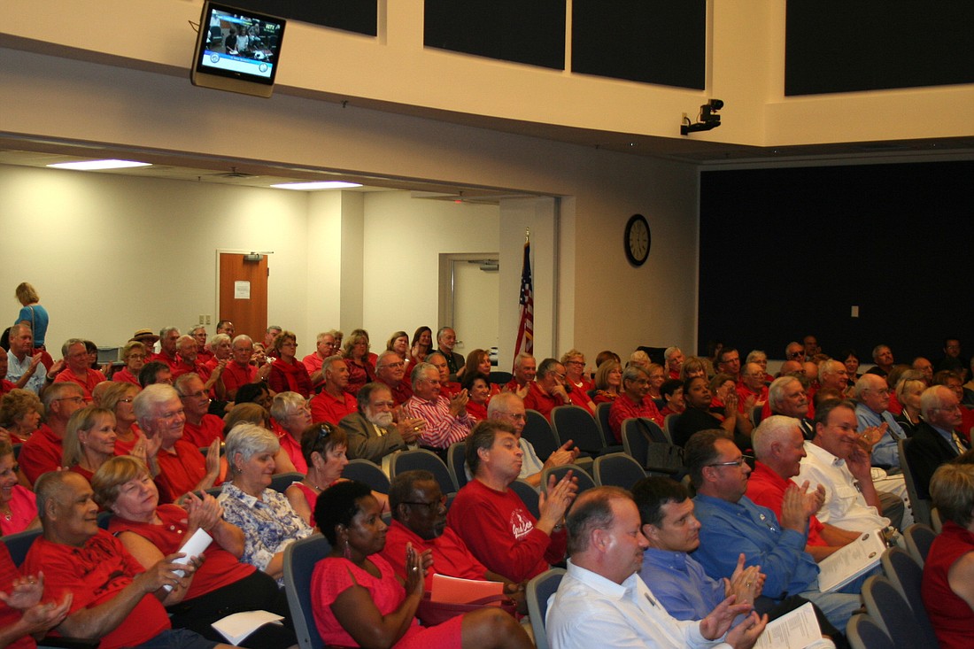 Members of the audience at a legislative delegation meeting Oct. 16 wore red shirts to support the fight against a state statute deregulating vacation rentals. (File photo by Jonathan Simmons)