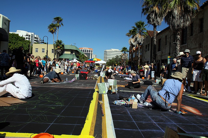 A view of Pineapple Avenue filled with chalk artists hard at work.