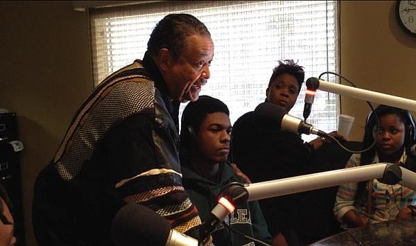 African American Mentoring Program President John Winston introduces his protege, Marcel Williams, Jan. 17, on "Free For All Friday," on WNZF. (Photo by Brian McMillan)