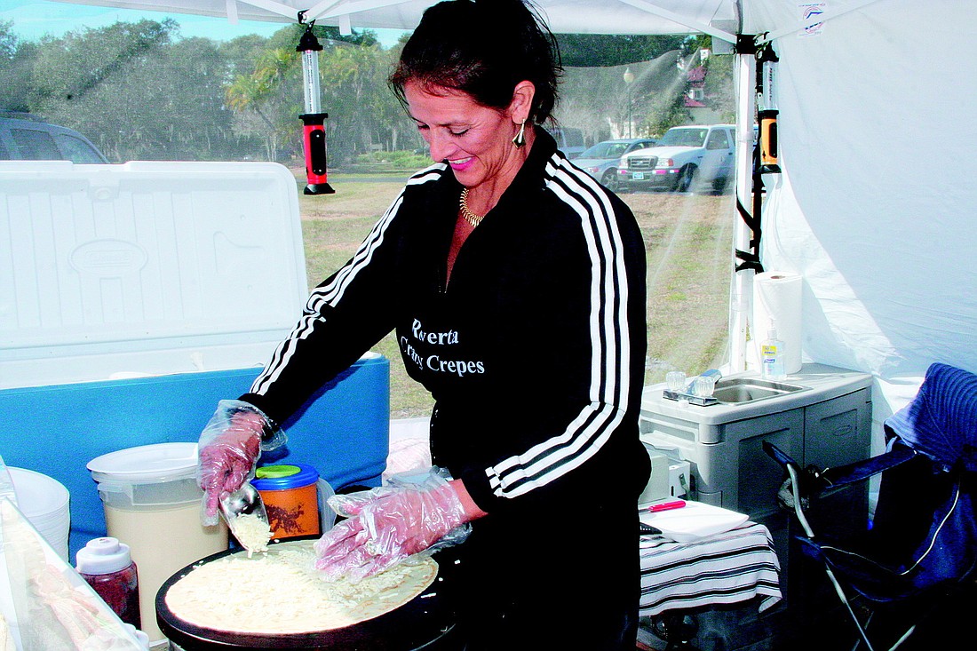 Roverta Winn sprinkles fresh mozzarella cheese onto a crÃƒÂªpe before adding mushrooms and a dollop of tomato-garlic sauce at the Phillippi Farmhouse Market's grand opening and ribbon-cutting in January.