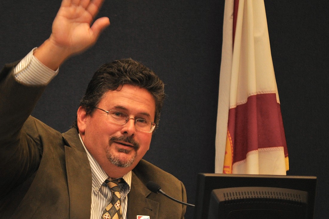 Flagler County School Board Chairman Andy Dance waves to Flagler Schools superintendent candidate Pamela Tapley at the board's Feb. 4 meeting. (Photo by Jonathan Simmons)